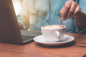 Businessmen are making coffee and working with notebooks.