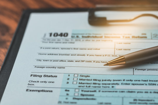 Close up of pen place on US tax form 1040