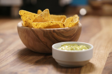 nachos with guacamole sauce on table
