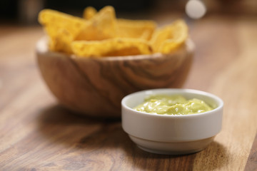 nachos with guacamole sauce on table