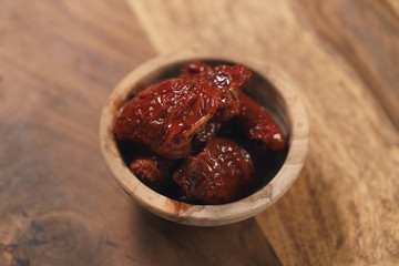 sundried tomatoes in wood bowl on table