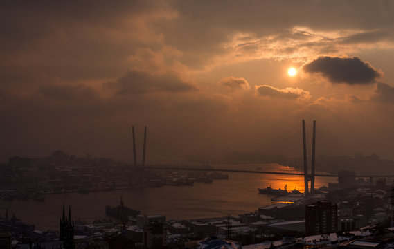 Vladivostok cityscape with dramatic sunset sky.