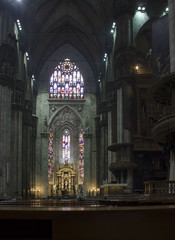 Fototapeta na wymiar Duomo Catheral in Milan, interiors of the liturgic area with benches and the altar, no people