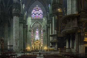 Fototapeta na wymiar Duomo Catheral in Milan, interiors of the liturgic area with benches and the altar, no people