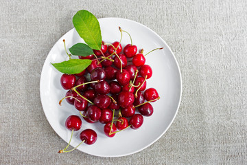 Sweet cherries on the white plate