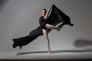 Graceful ballerina posing with black cloth © alexlukin