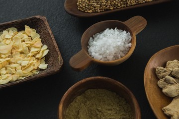 Various spices in bowl on black background