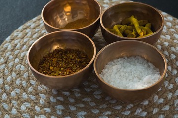 Various spices in bowl on a place mat