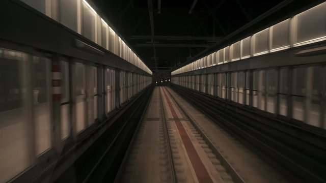 View of subway tunnel as seen from the rear window of moving train. Fast underground train departs from modern subway station. long footage of an underground train in Barcelona following its route