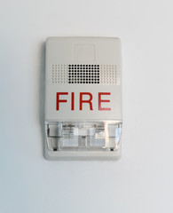 Fire alarm siren with flashing light strobe isolated on white