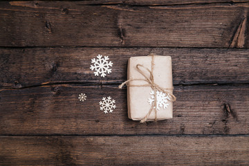 Christmas background with new year giftbox and cup of coffee on wood and xmas tree. Traditional festive Christmas dark background top view. Toned Vintage Effect.