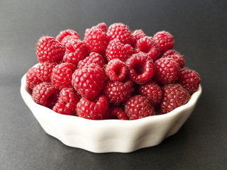 Fresh raspberries in a white bowl