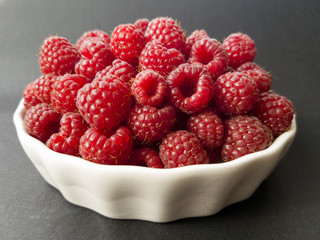 Fresh raspberries in a white bowl