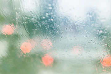 Fototapeta premium blur image of water car window glass with background of street in raining season