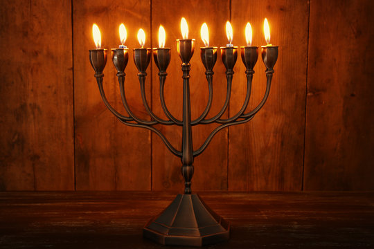 jewish holiday Hanukkah background with menorah (traditional candelabra) and burning candles