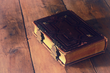 antique books, with brass clasps on old wooden table. fantasy medieval period and religious concept