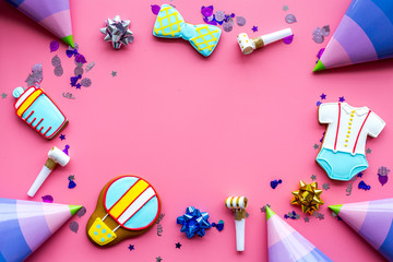 Cook gingerbread cookies with ticker tape for baby shower on pink background top view mockup