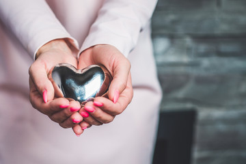 Hands and heart close to the belly. New life, pregnancy. New heart for a small man. Hearts given to...