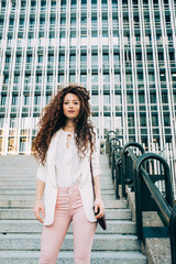 Young redhead business woman walking on the stairs