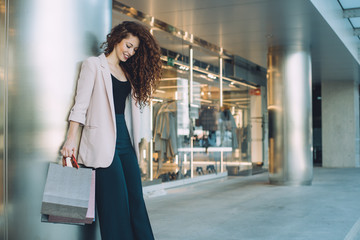 Happy beautiful young redhead woman doing shopping