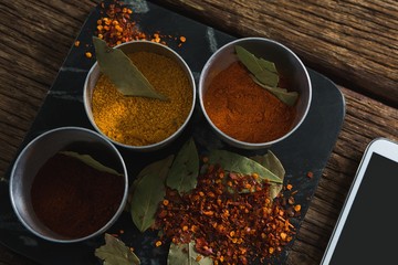 Various spices on wooden board