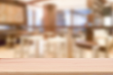 Wood table top with blur cafe interior to promote your products