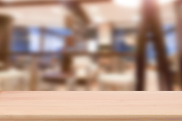 Wood table top with blur cafe interior to promote your products