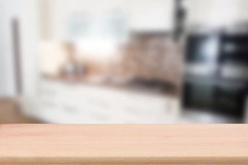 Wood table top with blur kitchen interior to promote your products