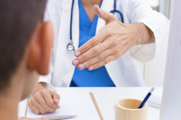 doctor in consultation greeting patient