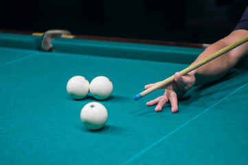 billiard green table in hall with white balls with man hand