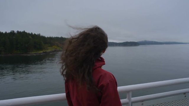 young caucasian female enjoying the view  on ferry in ocean 