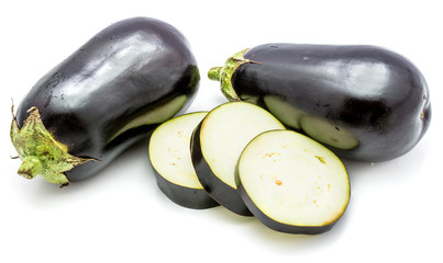 Two whole and sliced eggplants (aubergine), round slices, isolated on white background
