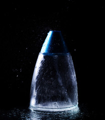 Perfume bottle and water splash
