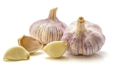 Two whole garlic bulbs and three cloves isolated on white background