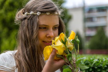 A beautiful girl with a yellow flower in her hand, the day of her holy communion