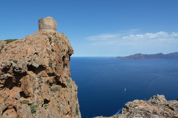 view of an ancient stone tower on a cliff above the sea, Corsica