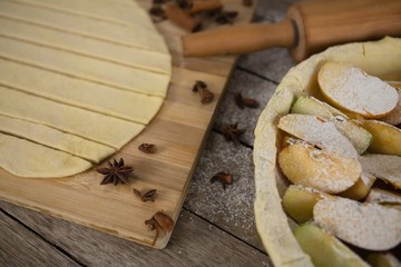 High angle view of pastry dough stripes on cutting board with