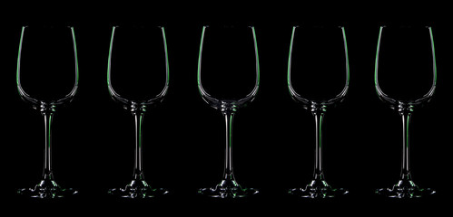 Silhouette of wineglass with green illumination