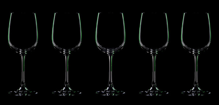 Silhouette of wineglass with green illumination