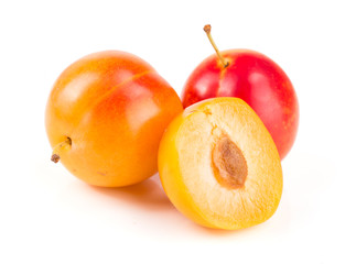 Yellow plums and half isolated on white background