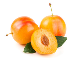 Yellow plum with leaves isolated on white background