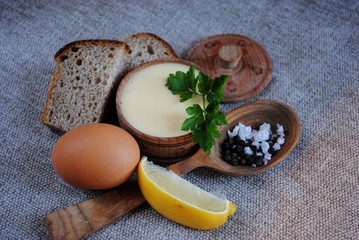 Mayonnaise sauce and ingredients on white wooden table. Top view