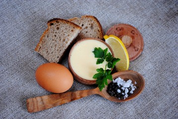 Mayonnaise sauce and ingredients on white wooden table. Top view