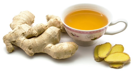 Ginger tea, fresh ginger rhizome and sliced pieces, isolated on white background