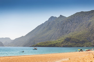 Fototapeta na wymiar Sea beach in Turkey with mountain and yacht