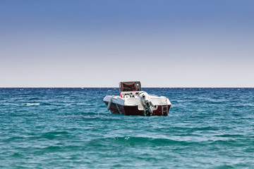 a motor boat stands in a sea bay, the concept of passenger transport in the beach resort