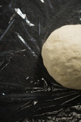 Overhead view of dough on plastic wrap