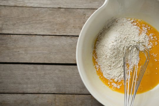 Flour on egg yolk in container