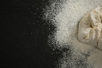Cropped image of flour on dough