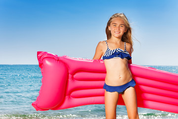 Young girl in bikini with pink inflatable mattress - obrazy, fototapety, plakaty
